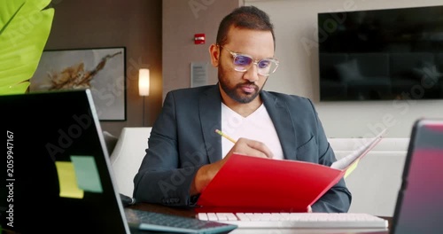 Businessman reviewing documents in modern office setting
