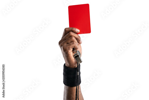 Foto Referee hand holding red card and metal whistle