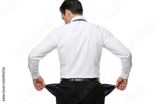 Foto Businessman pulling out empty pockets from behind