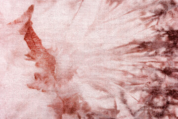 Macro view of tie dye fabric texture with red accents