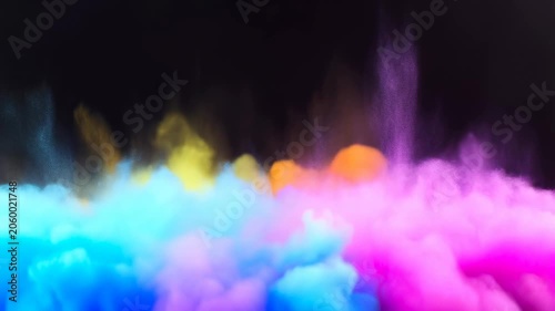 Colorful smoke clouds swirling against a dark background. Vibrant visual effects for creative projects and artistic expressions