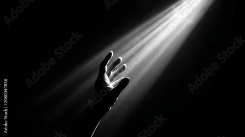 Hand Reaching Toward Divine Light in Darkness Symbolizing Hope Faith and Spiritual Guidance