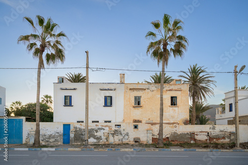Contrast of Renovated and Abandoned Spanish Colonial Buildings on a Street at Sunset - Sidi Ifni, Morocco