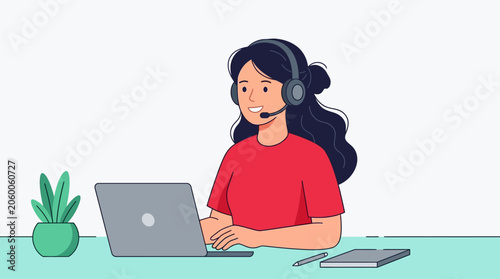 woman wearing headset working on laptop computer at desk with plant