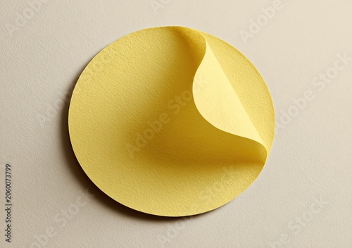 A single yellow circular sticker with a peeling corner.