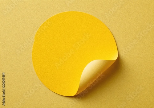 Blank Yellow Circle Sticker with Peeling Corner on Yellow Background.