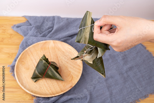 Holding a fresh zongzi in hand