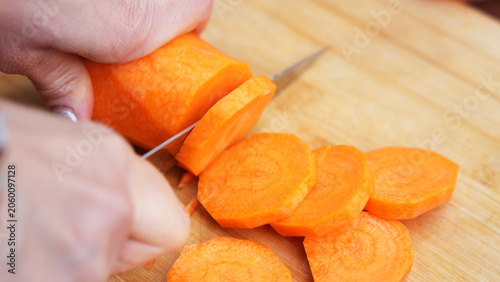 extreme close up of cutting carrots on the wooden board