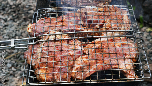 close up of meat in the metal grid, raw meat, beef, cooking