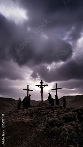 Dramatic depiction of the Crucifixion on Golgotha: three silhouetted crosses against a stormy sky, the central cross bearing Jesus while mourners stand in solemn vigil.