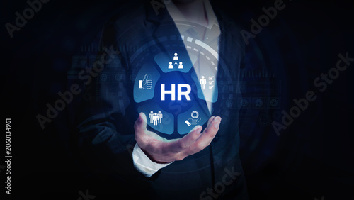 HR Human Resources Concept: A hand holds a glowing blue sphere displaying the HR acronym and various human resource icons, symbolizing the management and development of people within an organization.