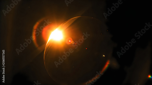Abstract glowing bubble with bright lens flare on black background