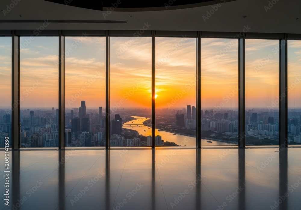 Fototapeta premium Sunset cityscape viewed through floor-to-ceiling windows at dusk
