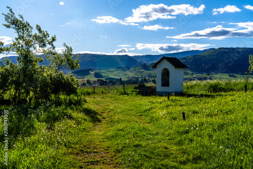 Small Chapel in Mountain Meadow Landscape
