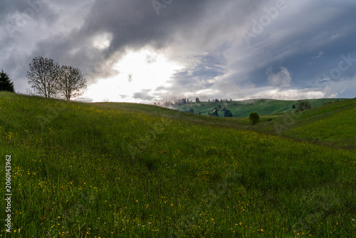 Stormy Meadow Landscape With Rolling Hills