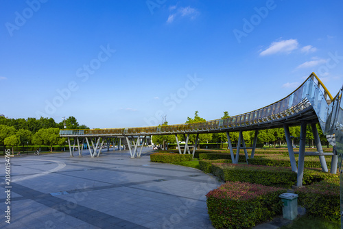 Fényképezés Modern Curved Pedestrian Bridge in a Park