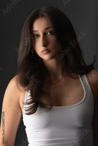 Young woman looking at camera, featuring beauty, fashion, and natural elegance