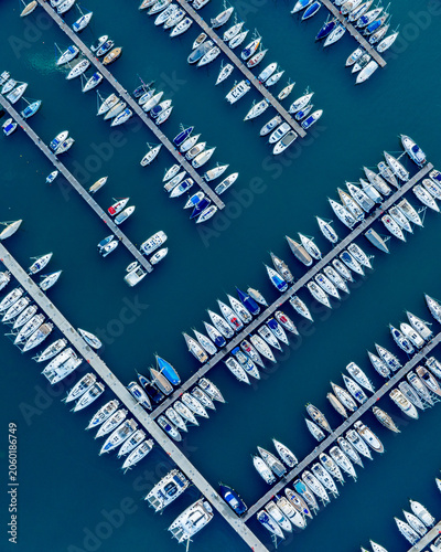 Aerial view of a marina filled with sailboats and yachts.
