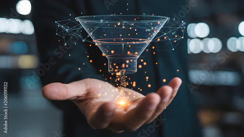 Businessman holding a digital funnel with glowing orange particles