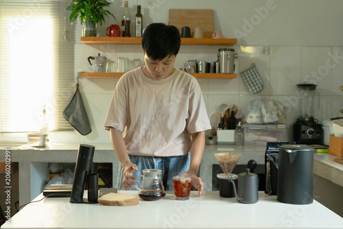 Asian preparation Pour drip coffee a healthy caffeinated beverage enjoyed in the home kitchen in the morning.