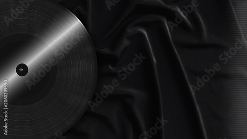 Black Vinyl Record Spinning on Dark Velvet Fabric Background
