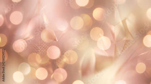 Abstract soft rose gold background containing beautiful geometric bokeh lights.