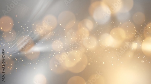 Luxurious horizontal gold background filled with soft sparkling light bokeh.