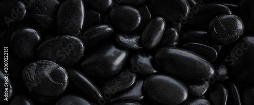 Photography Dark smooth black pebbles background with glossy texture and minimalist zen spa