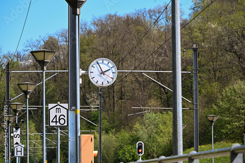 Railway station clock and overhead power lines