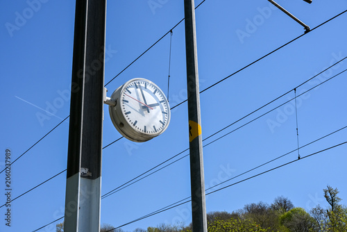 Railway station clock and overhead power lines