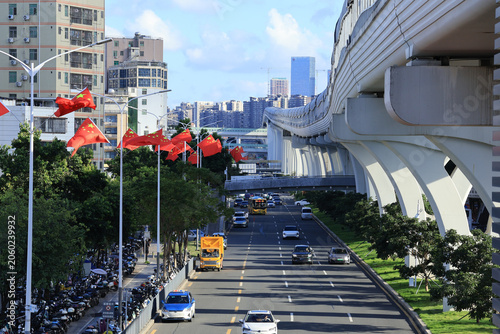 Fotografie Urban boulevard in China with national flags and elevated viaduct