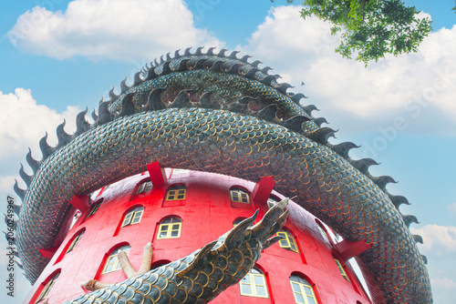 Dragon Temple Wat Samphran with Blue Sky Background, low angle view of the iconic pink dragon tower at Wat Samphran temple under a beautiful blue sky in Nakhon Pathom, Thailand.