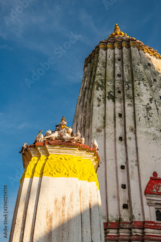 Ancient Buddhist Swayambhu temple architecture against blue sky, Kathmandu landmark.