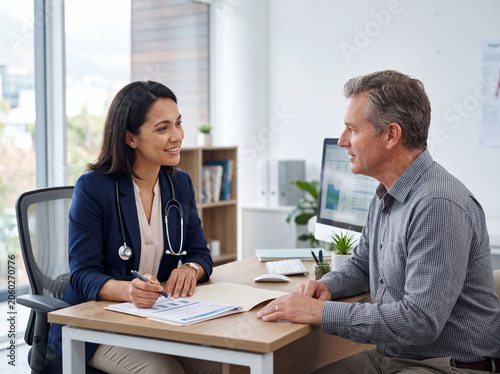 Doctor consulting patient in modern clinic office