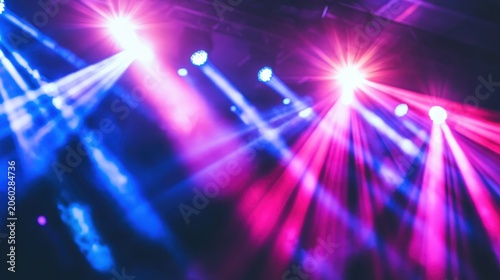 Vibrant stage lighting with pink and blue beams illuminating a dynamic venue for exciting events