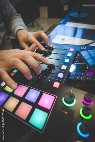 Music Producer Using MIDI Controller and Faders in Studio