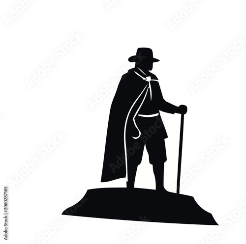 Silhouette of a Pilgrim Man Standing on a Rock.