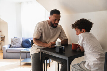 Father and son watching smartphone at home