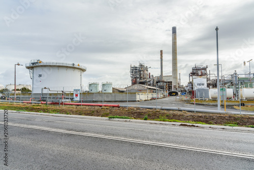Smokestacks and distillation towers in a petrochemical plant on a cloudy autumn day