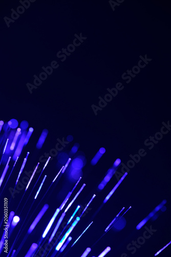 Canvas Print Blurred purple fiber optic lights ascend diagonally from bottom corner into deep dark space