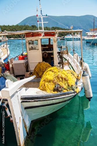 Beautiful scenic landscape with a boat with fishing rods on the embankment in Greece. Stunning amazing charming places.