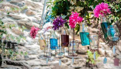 Garden party floral arrangement with hanging glass bottle wedding decor