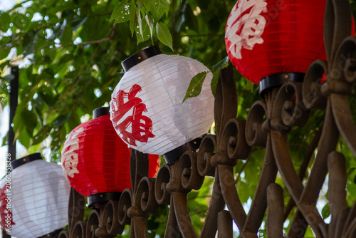 Japanese Festival Lanterns Red and White Paper Lanterns Hanging on Decorative Iron Fence