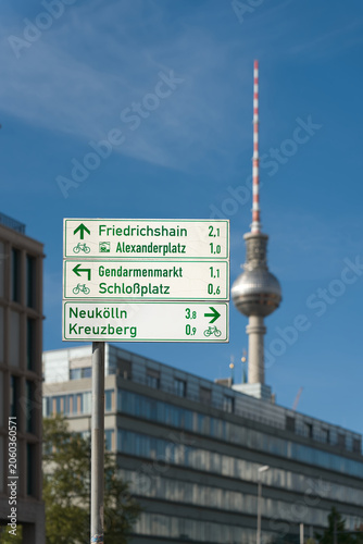 Signpost in downtown Berlin. In the background is the TV Tower, the city's landmark 