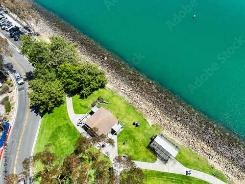 The Dana Point California  Harbor from above the Richard Henry Dana Statue using a UAV Drone looking at the harbor and the breakwaters protecting the harbor and the inlet from Pacific Oacea Waves
