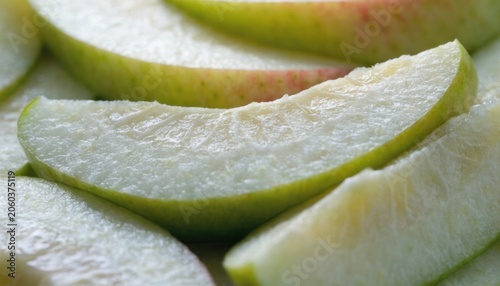 Close-up of fresh green apple slices showing texture and moisture on the fruit's surface.