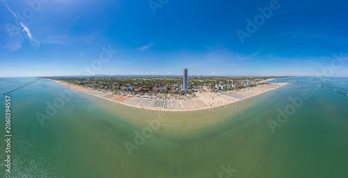 Cesenatico, Italy, June 8, 2026: Aerial view of the coastal landscape, featuring the iconic skyscraper, busy beach umbrellas, and the Adriatic Sea on a sunny summer day.