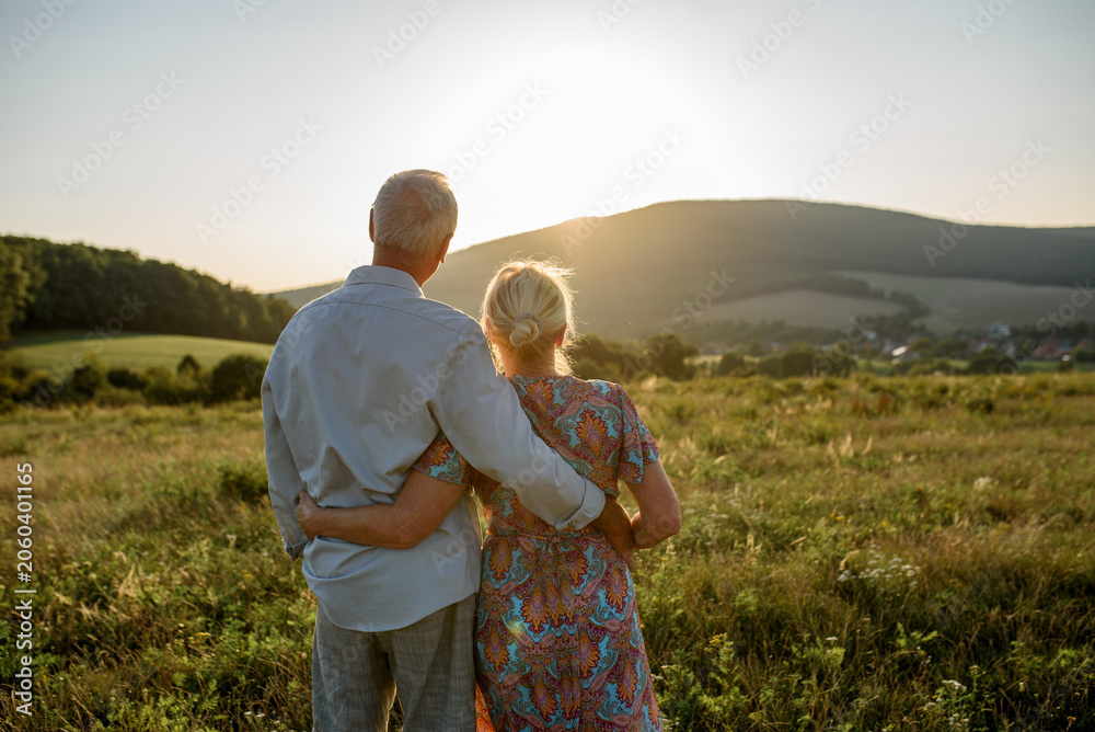 Fototapeta premium Senior couple on walk during sunset.