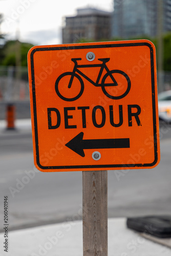 Bike route detour directional sign on street