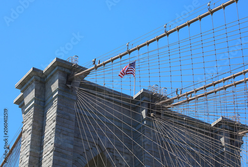 American flag waving on the Brooklyn Bridge tower